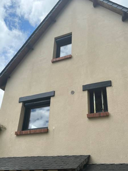 ETANEL Image d'une maison rénovée à Saint-Paër avec fenêtres et volets roulants installés.