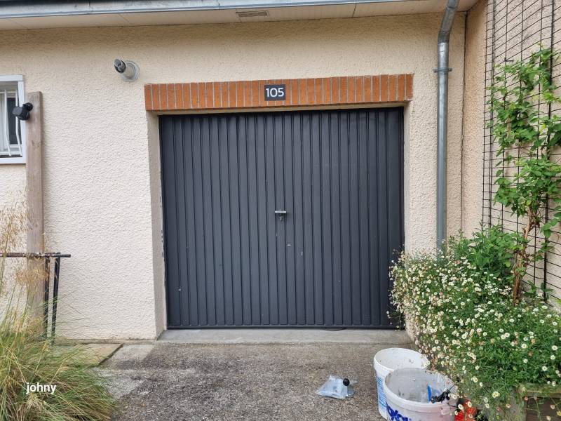 Une porte de garage battante avec des vantaux inégaux pour un accès piéton facilité et un plus grand espace de rangement à l'intérieur du garage